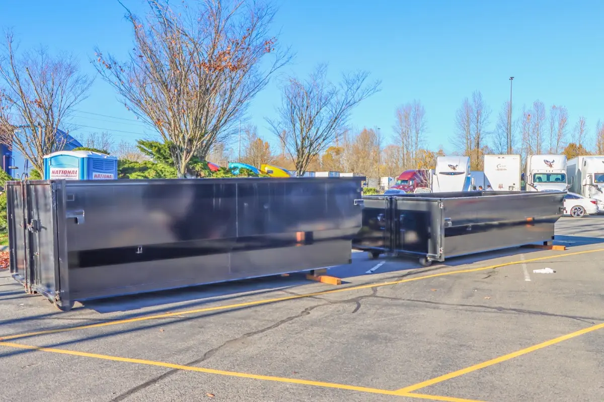 Professional dumpster rental service with roll-off container on residential driveway in Camp Hill